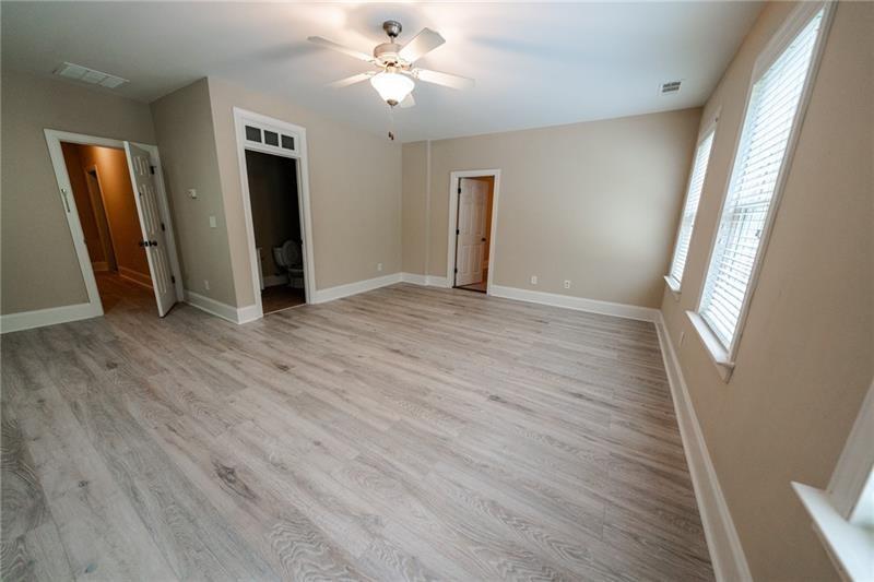 3245 Sparling Street Cumming, GA 30041 - Photo 38 of 59 a view of an empty room with wooden floor and a window
