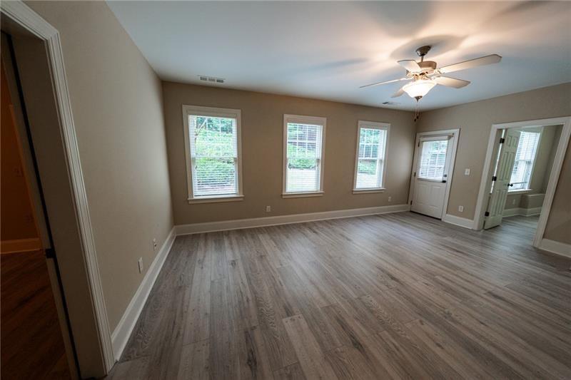 3245 Sparling Street Cumming, GA 30041 - Photo 39 of 59 an empty room with wooden floor and windows