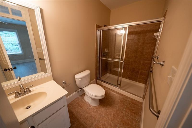 3245 Sparling Street Cumming, GA 30041 - Photo 40 of 59 a bathroom with a sink and a mirror