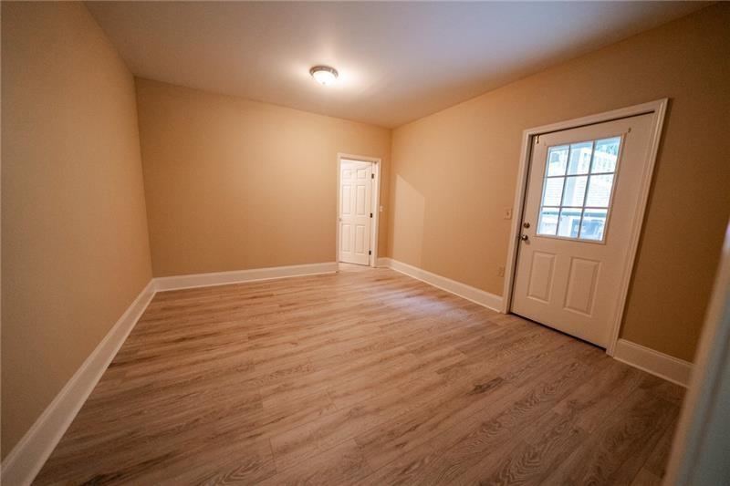 3245 Sparling Street Cumming, GA 30041 - Photo 42 of 59 an empty room with wooden floor and windows