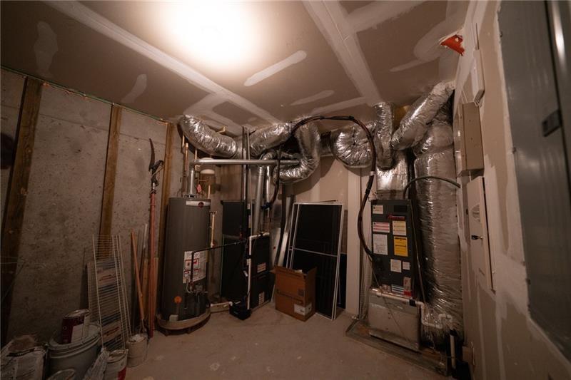 3245 Sparling Street Cumming, GA 30041 - Photo 44 of 59 a view of walk in closet with clothes and shoes
