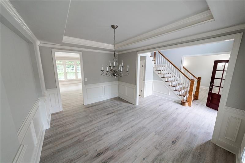 3245 Sparling Street Cumming, GA 30041 - Photo 7 of 59 a view of a hallway with wooden floor and stairs