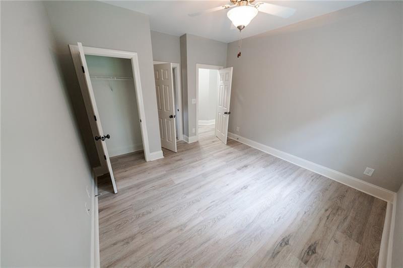 3245 Sparling Street Cumming, GA 30041 - Photo 9 of 59 wooden floor in an empty room with a window