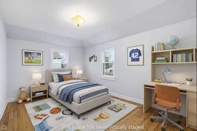 a bedroom with a bed and a desk