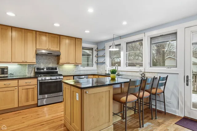 a kitchen with a stove a sink and cabinets