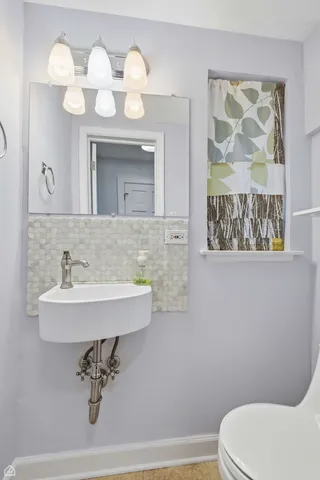 a bathroom with a sink a mirror and a toilet