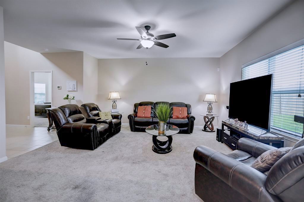 1303 Emerald Stone Drive Rosharon, TX 77583 - Photo 3 of 25 Inviting open-concept living room that creates the perfect space for gathering with family and friends.