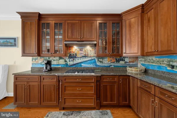a kitchen with stainless steel appliances granite countertop a sink and cabinets