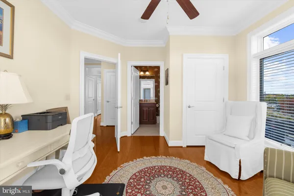 a bathroom with a granite countertop sink a toilet a mirror a bathtub and shower