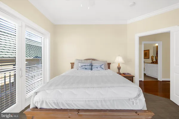 a bedroom with a large bed and a large window