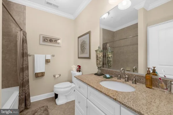 a bathroom with a granite countertop tub sink and mirror