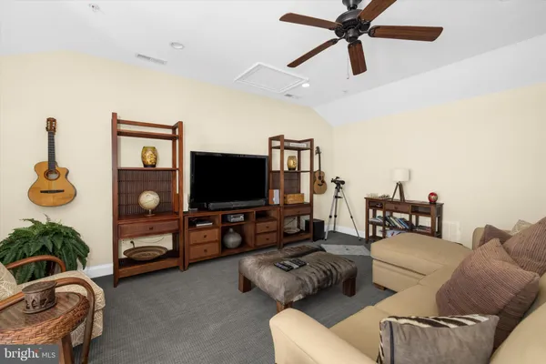 a living room with furniture a piano and a window