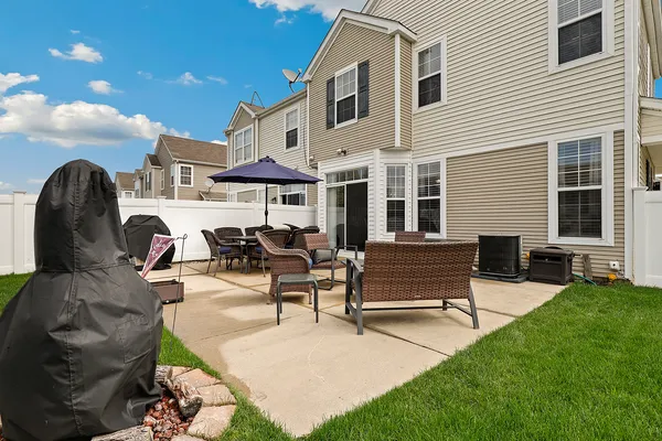 a view of a house with backyard and sitting area