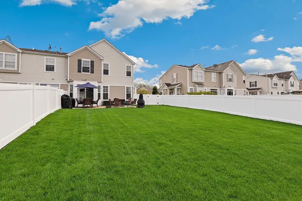 a front view of a house with a garden and yard