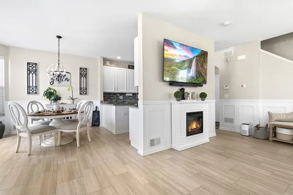 a living room with furniture wooden floor and a fireplace