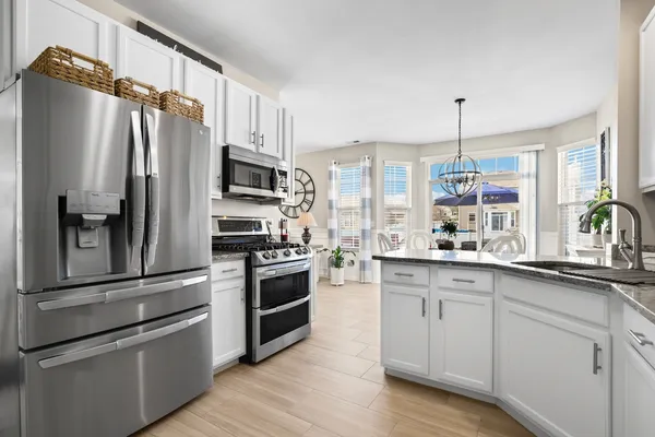a kitchen with a refrigerator and a sink