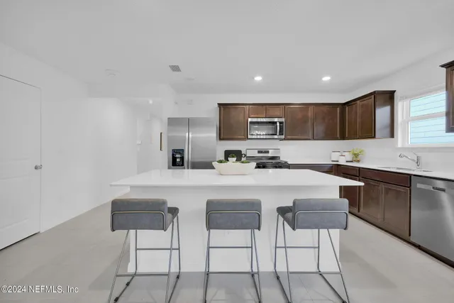 a dining room with furniture window and wooden floor
