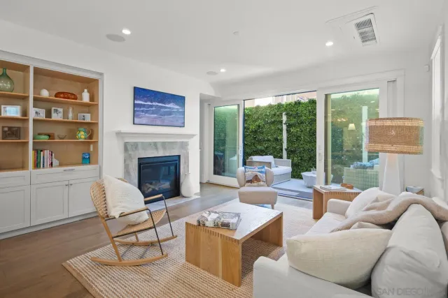 a living room with furniture a large window and a fireplace