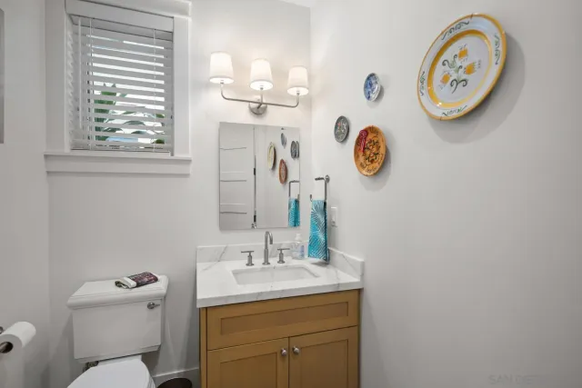 a bathroom with a toilet a sink and a mirror