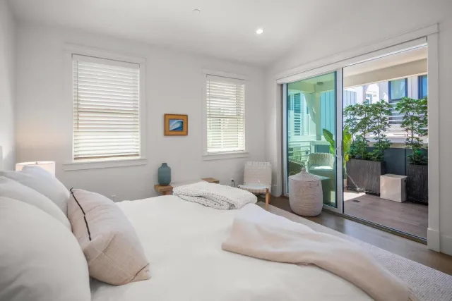 a bedroom with a large bed and a large window