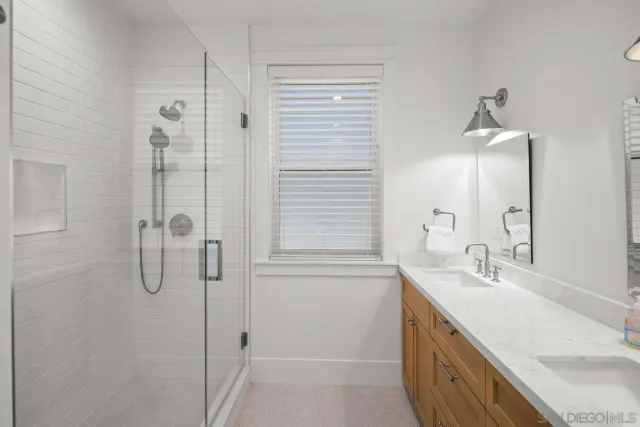a bathroom with a shower sink and mirror