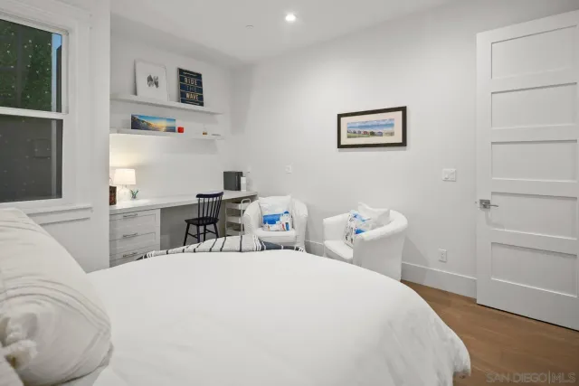 a bedroom with a bed and a table in it