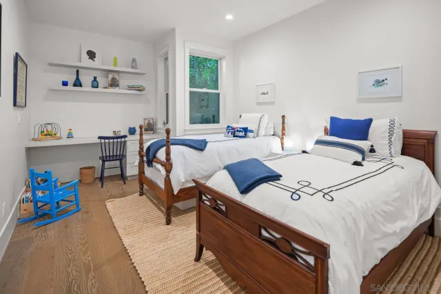 a living room with furniture and painting on the wall