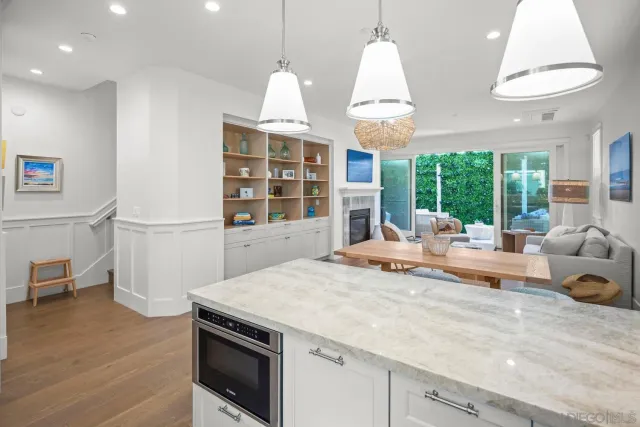 a kitchen with stainless steel appliances granite countertop a stove a refrigerator and a wooden cabinets