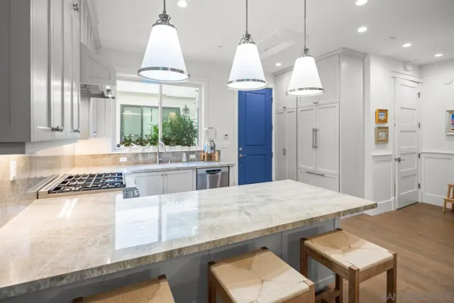 a kitchen with stainless steel appliances granite countertop a stove a refrigerator and a wooden cabinets