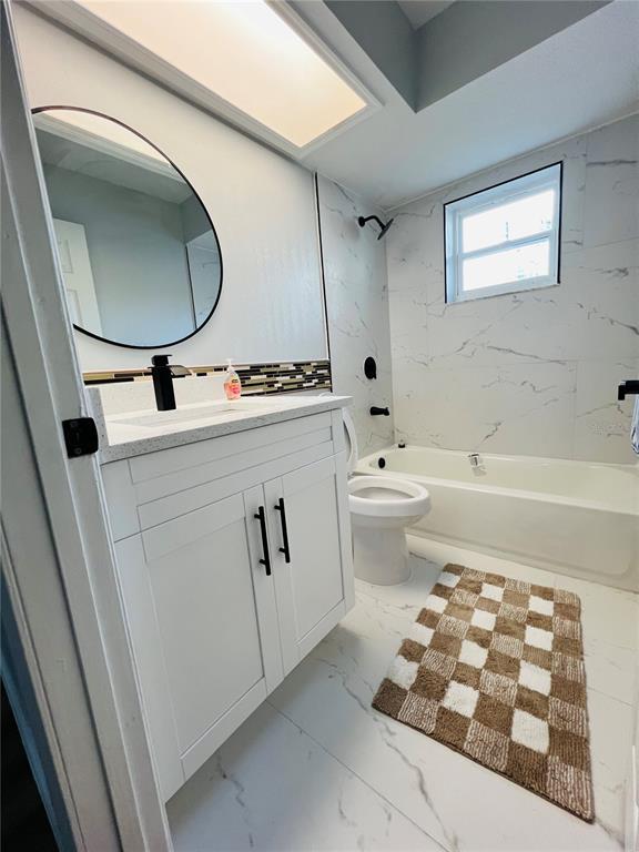 12195 71st Way Largo, FL 33773 - Photo 13 of 31 a bathroom with a sink a toilet and a mirror