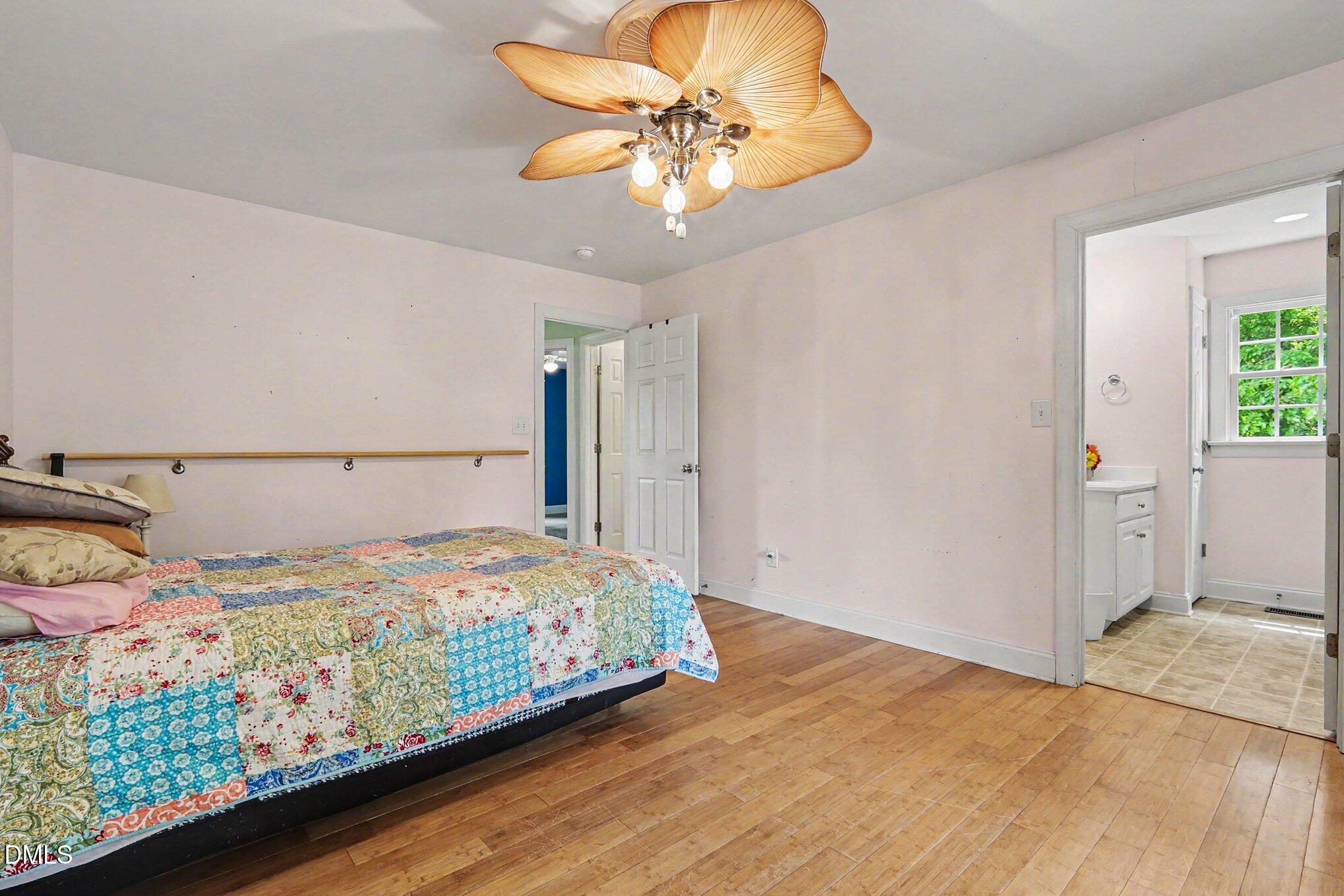 1750 Tom Oakley Road Timberlake, NC 27583 - Photo 16 of 31 a bedroom with a bed and a chandelier