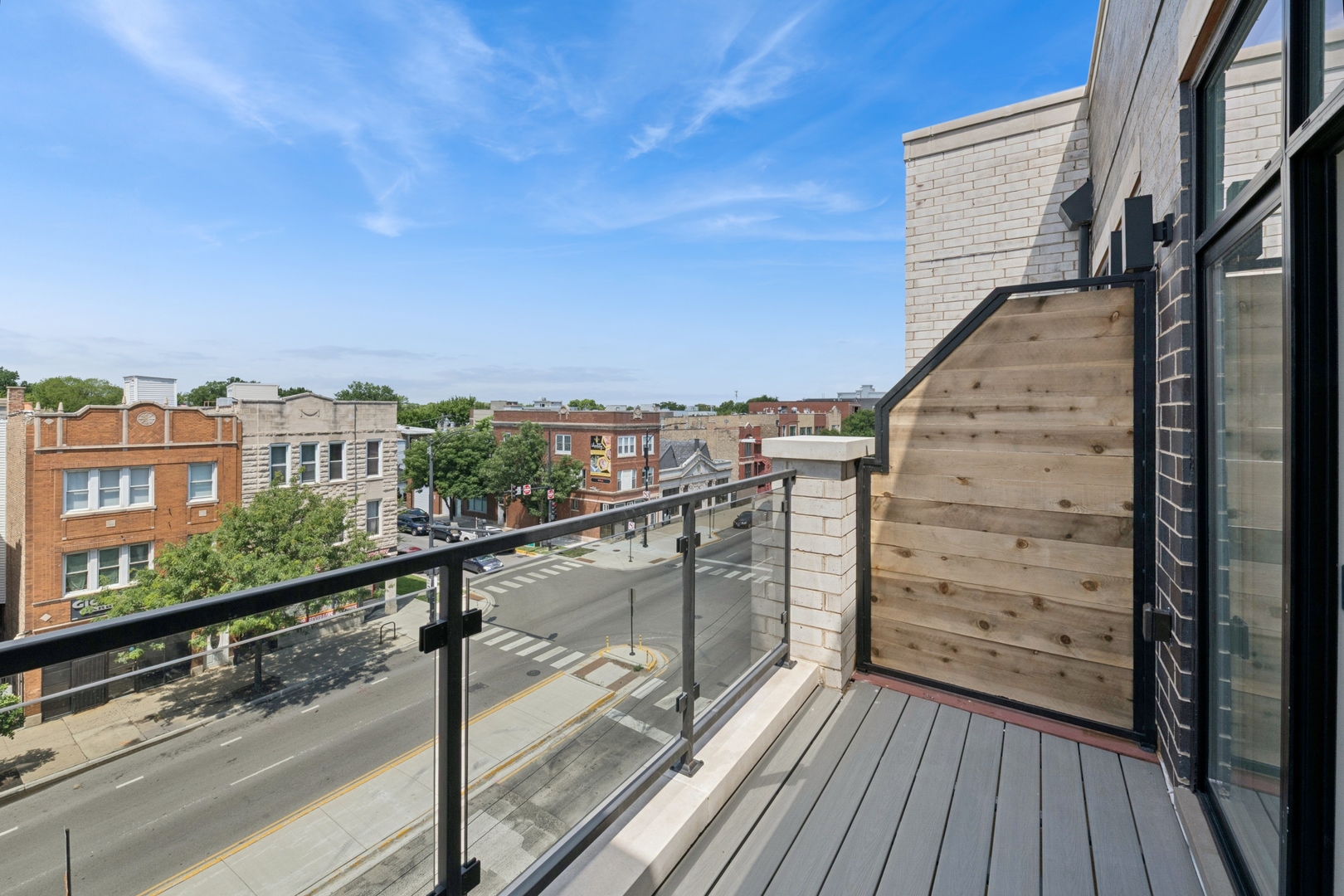 1355 North Western Avenue, Unit 2B Chicago, IL 60622 - Photo 13 of 16 a view of balcony with wooden floor and fence and a potted plant