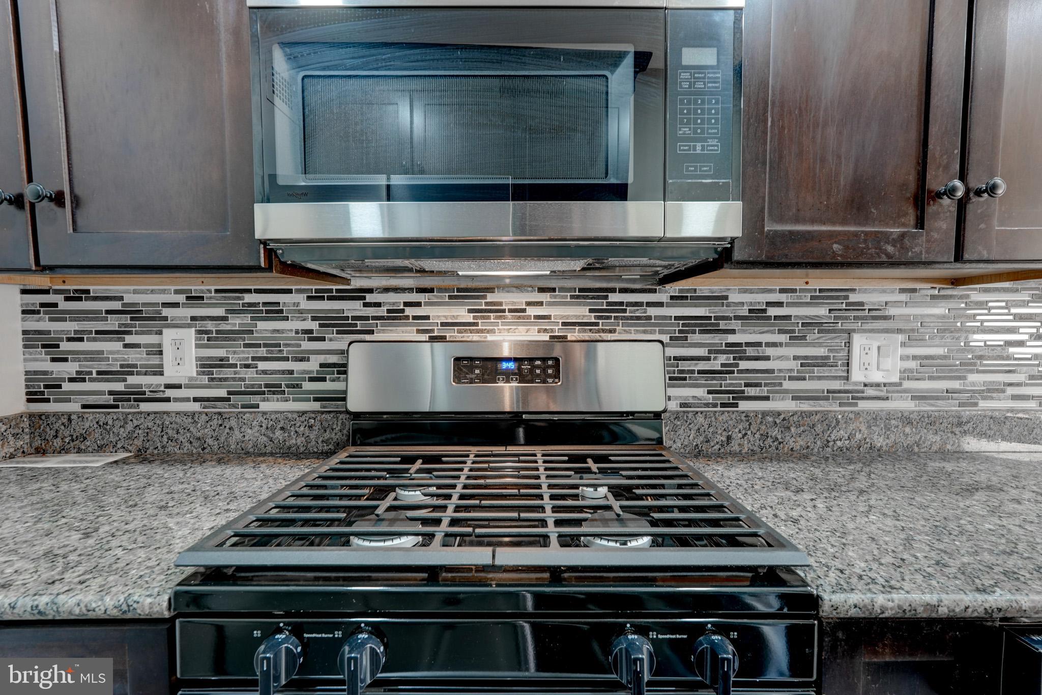 1900 Lyttonsville Road, Unit 211 Silver Spring, MD 20910 - Photo 11 of 46 a stove top oven sitting inside of a kitchen