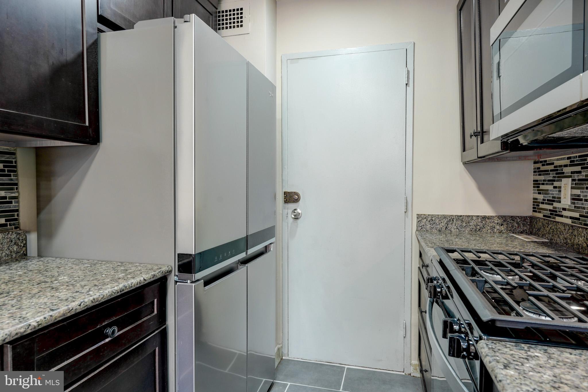 1900 Lyttonsville Road, Unit 211 Silver Spring, MD 20910 - Photo 18 of 46 a kitchen with a stove and a refrigerator