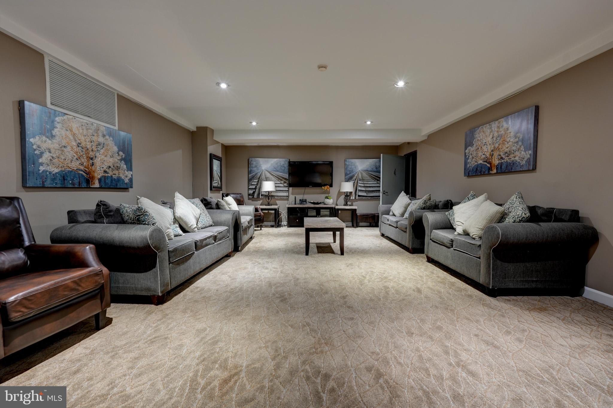 1900 Lyttonsville Road, Unit 211 Silver Spring, MD 20910 - Photo 37 of 46 a living room with furniture and a couch