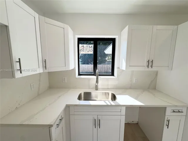 a kitchen with a sink and cabinets