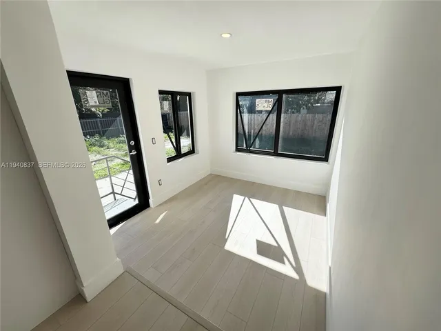 a view of an entryway with wooden floor