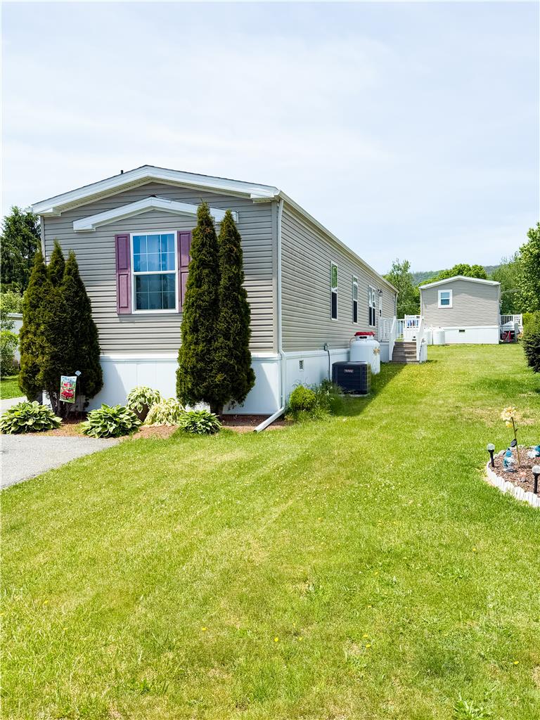 49 Ritz Craft Street Walnutport, PA 18088 - Photo 1 of 17 A well-maintained manufactured home with lush green lawn, featuring an additional storage shed.