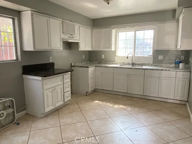 a kitchen with a sink a stove a microwave and cabinets
