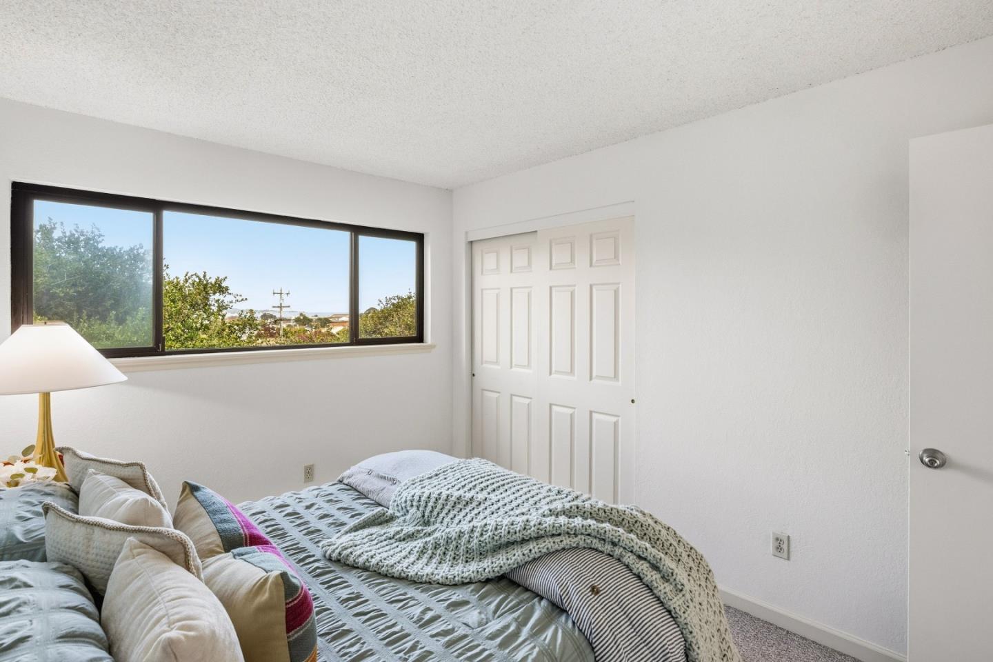 1186 Trinity Avenue Seaside, CA 93955 - Photo 21 of 33 a bedroom with a bed and a painting on the wall