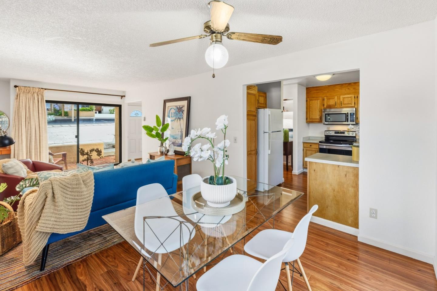 1186 Trinity Avenue Seaside, CA 93955 - Photo 6 of 33 a view of a dining room with furniture a chandelier and wooden floor