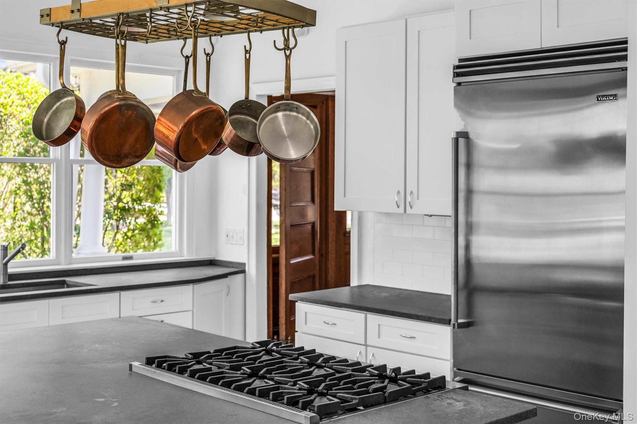64 South Howells Point Road Bellport, NY 11713 - Photo 11 of 42 a kitchen with stainless steel appliances granite countertop a stove and a refrigerator