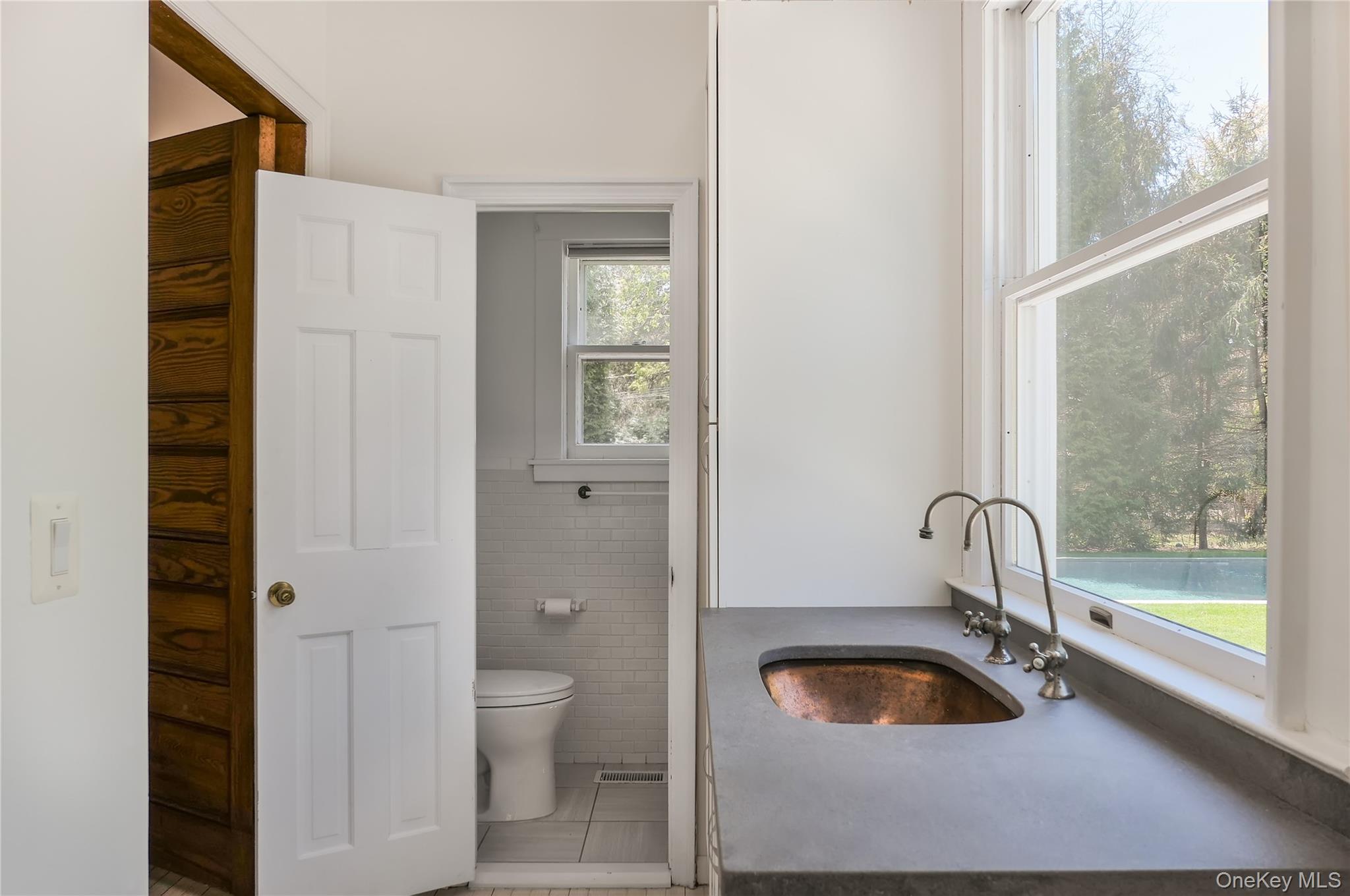 64 South Howells Point Road Bellport, NY 11713 - Photo 12 of 42 a bathroom with a tub and a sink