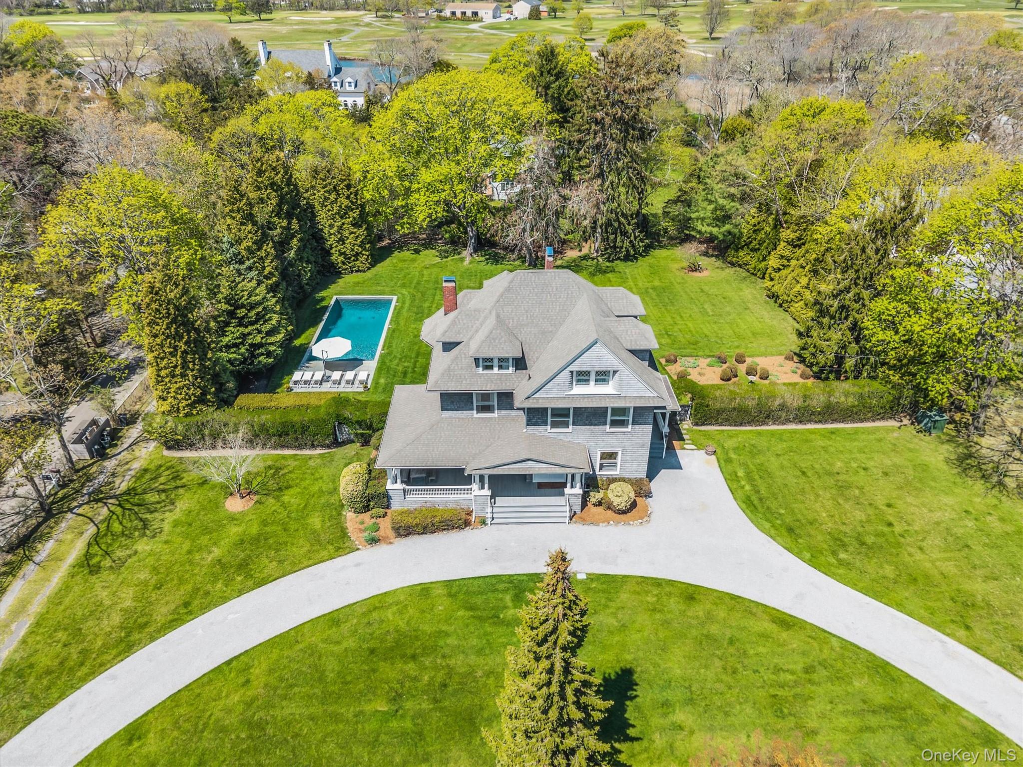 64 South Howells Point Road Bellport, NY 11713 - Photo 2 of 42 a view of a house with a yard porch and sitting area