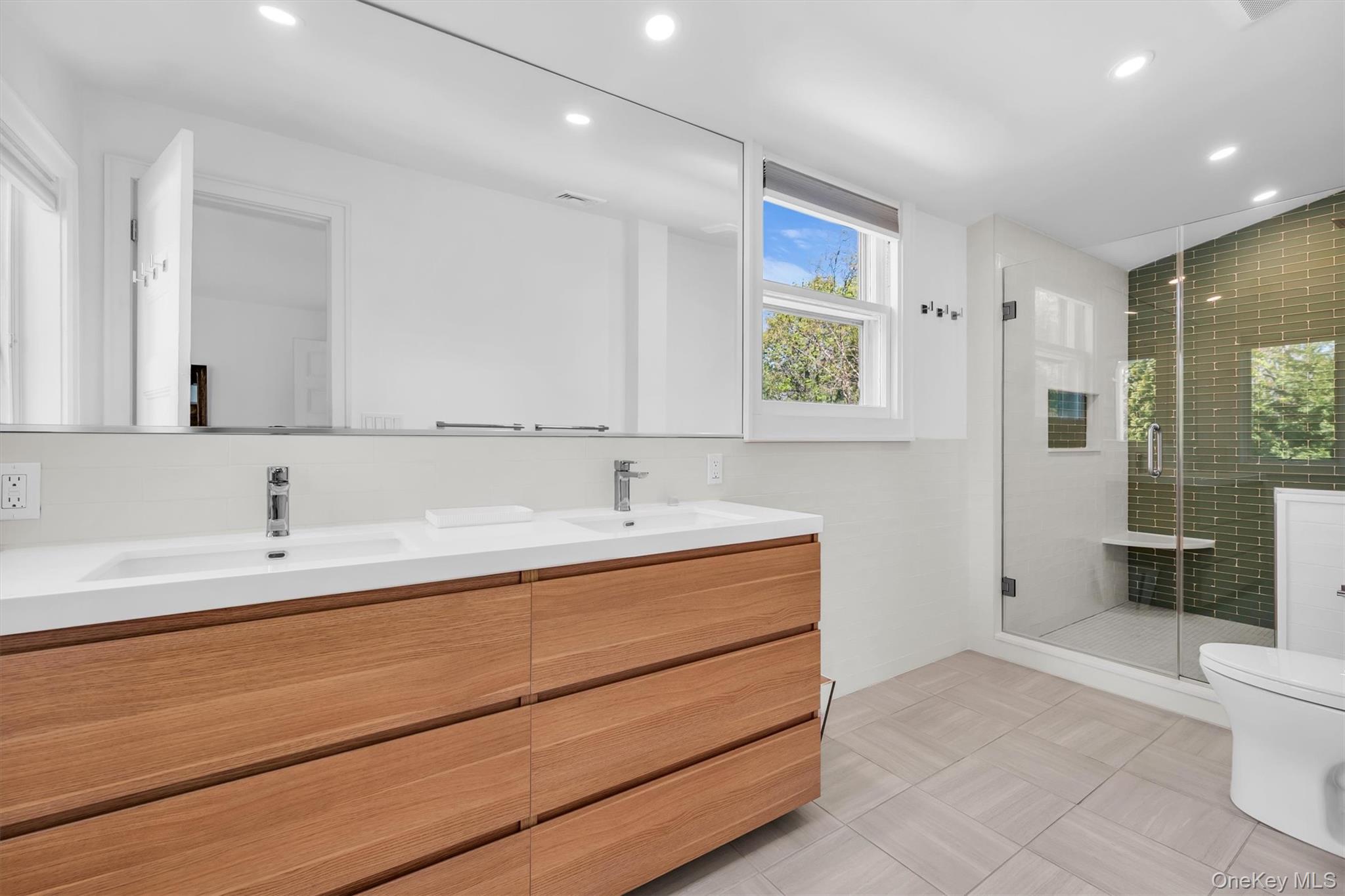 64 South Howells Point Road Bellport, NY 11713 - Photo 21 of 42 a bathroom with a sink and a mirror
