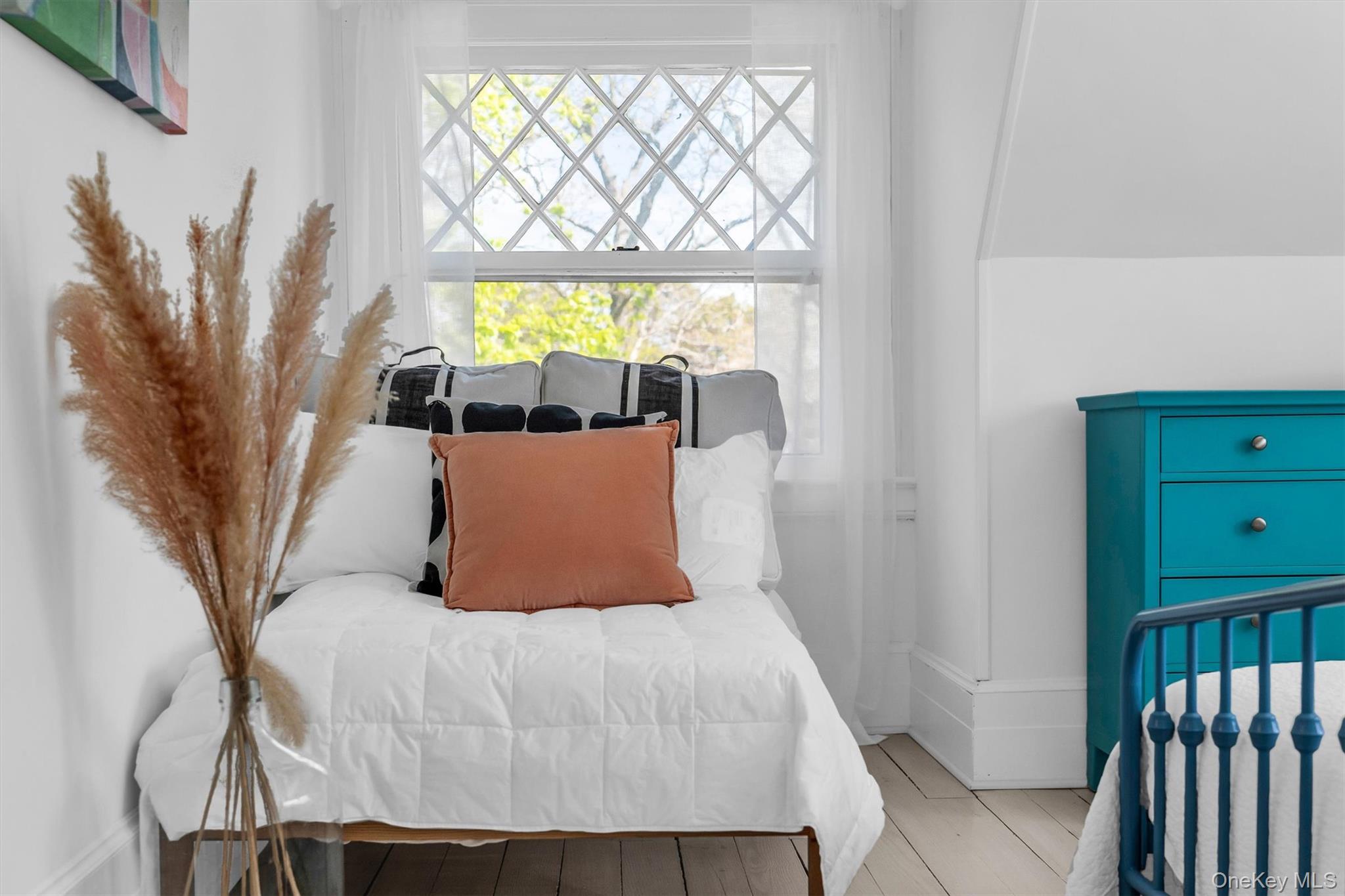 64 South Howells Point Road Bellport, NY 11713 - Photo 23 of 42 a bedroom with a bed and a window