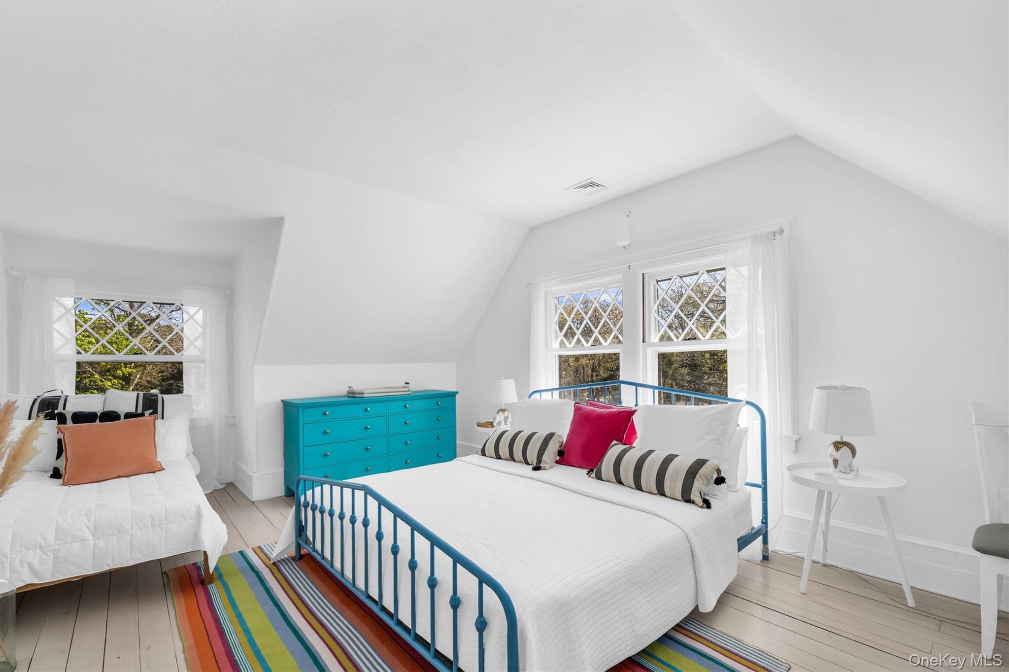 64 South Howells Point Road Bellport, NY 11713 - Photo 28 of 42 a bedroom with two beds and a window