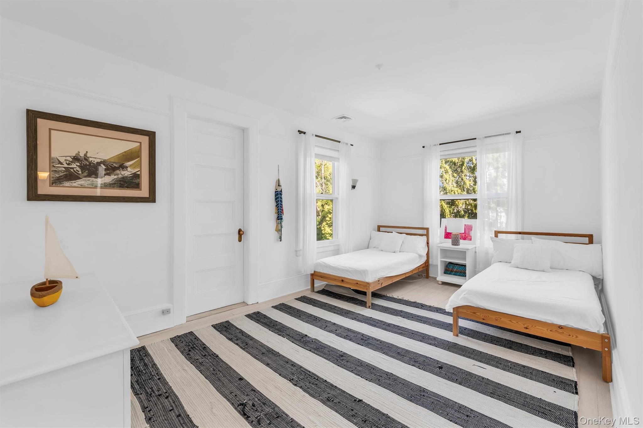 64 South Howells Point Road Bellport, NY 11713 - Photo 29 of 42 a bedroom with a bed and wooden floor