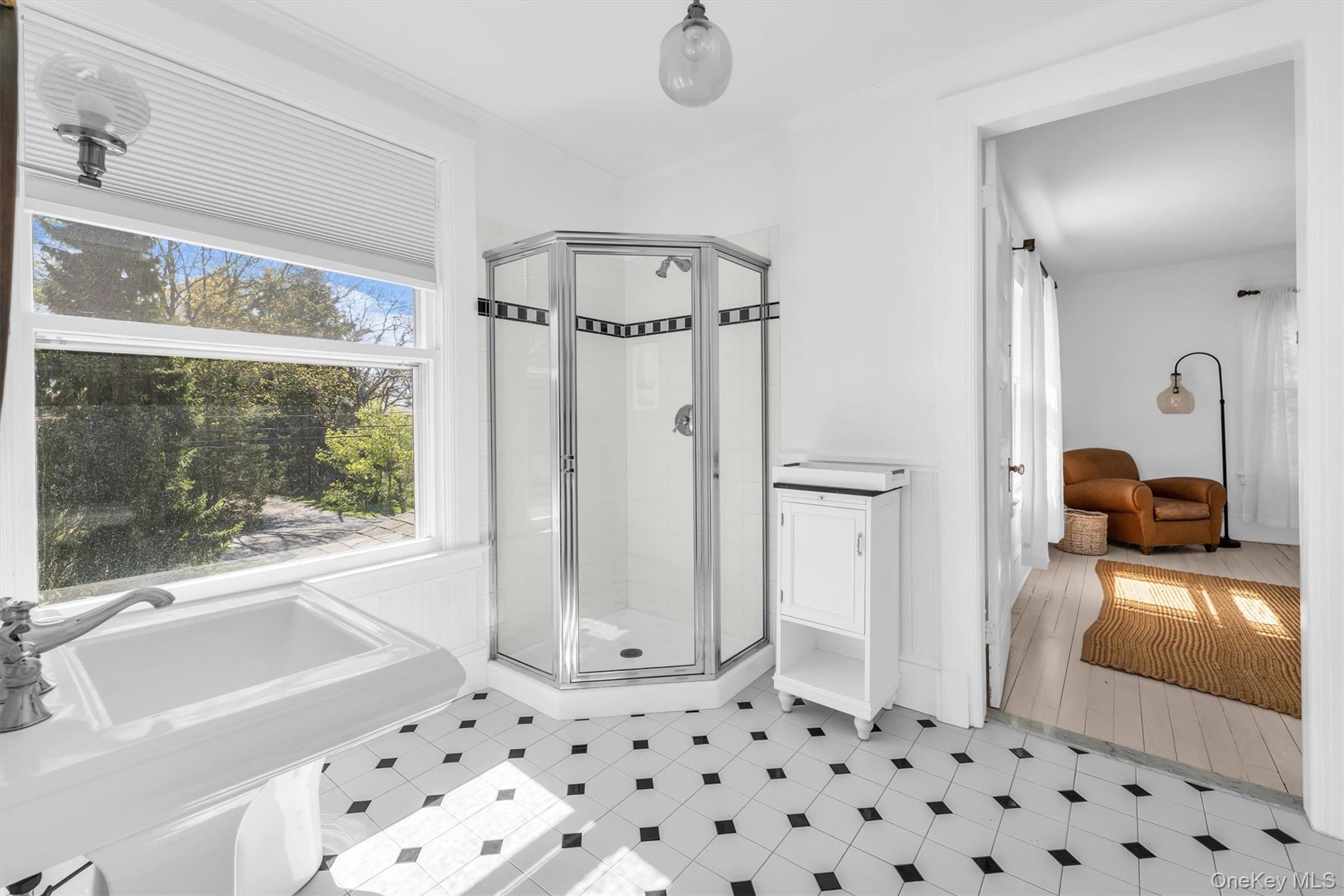64 South Howells Point Road Bellport, NY 11713 - Photo 33 of 42 a bathroom with a sink a large mirror and a shower