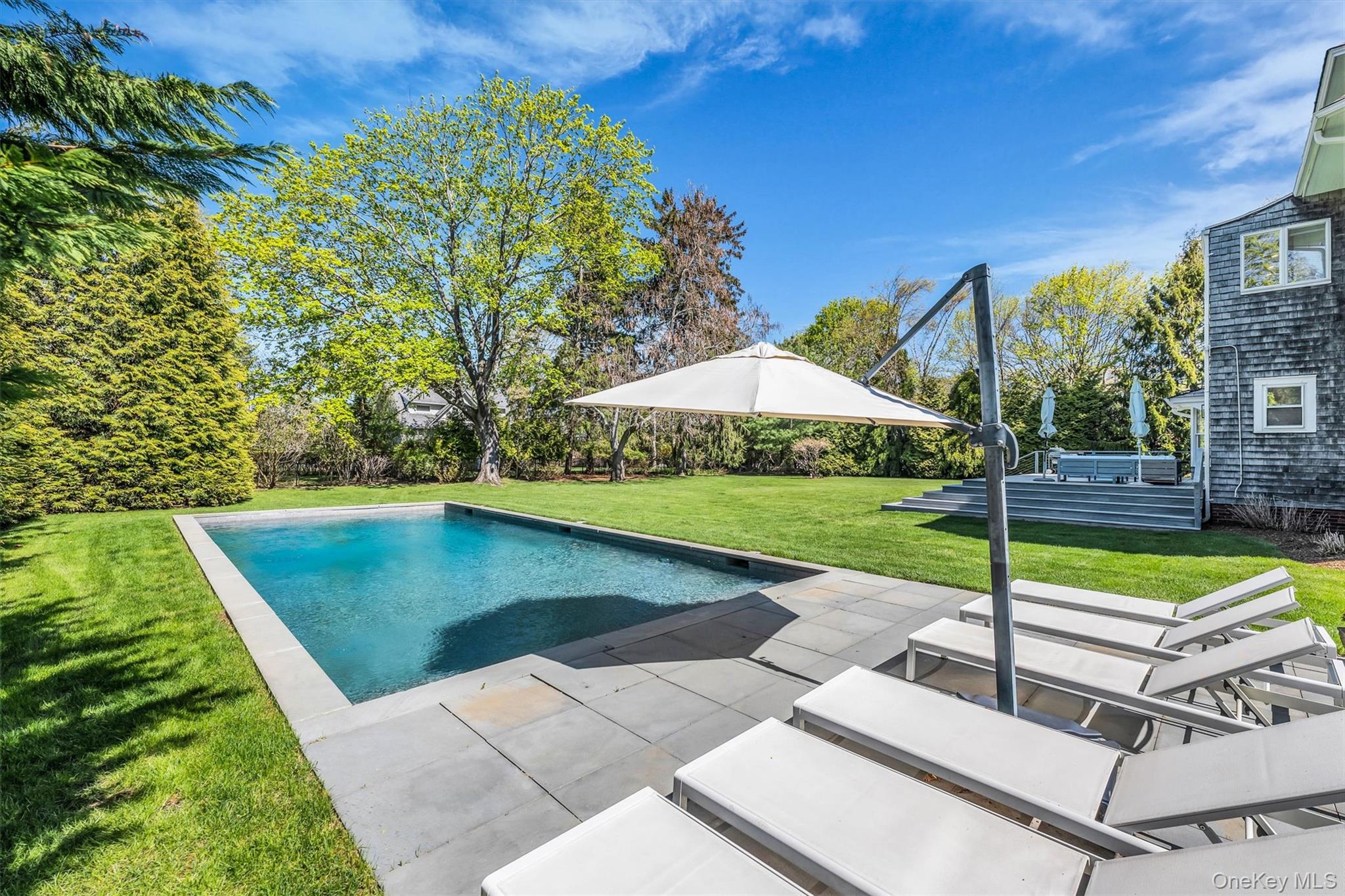 64 South Howells Point Road Bellport, NY 11713 - Photo 37 of 42 a view of a backyard with a patio